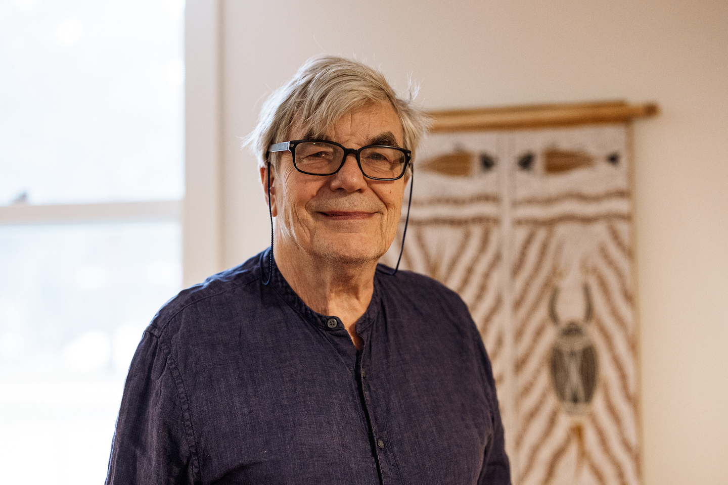 ANU Emeritus Professor Professor Howard Morphy A profile picture of Howard Morphy standing in front of a First Nations artwork