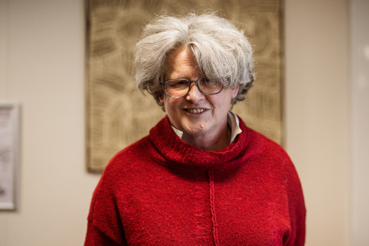 Dr Robyn McKenzie, a research fellow at ANU College of Health and Medicine and ANU College of Arts and Social Sciences A profile picture of Robyn McKenzie standing in front of a First Nations artwork