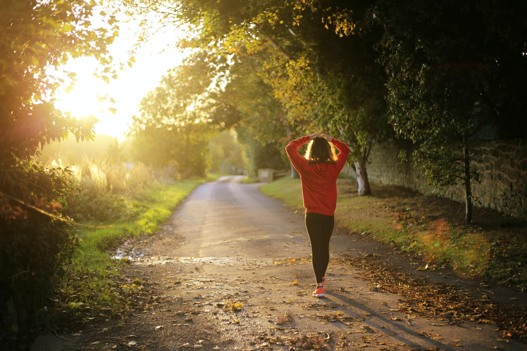 Woman walking at sunrise