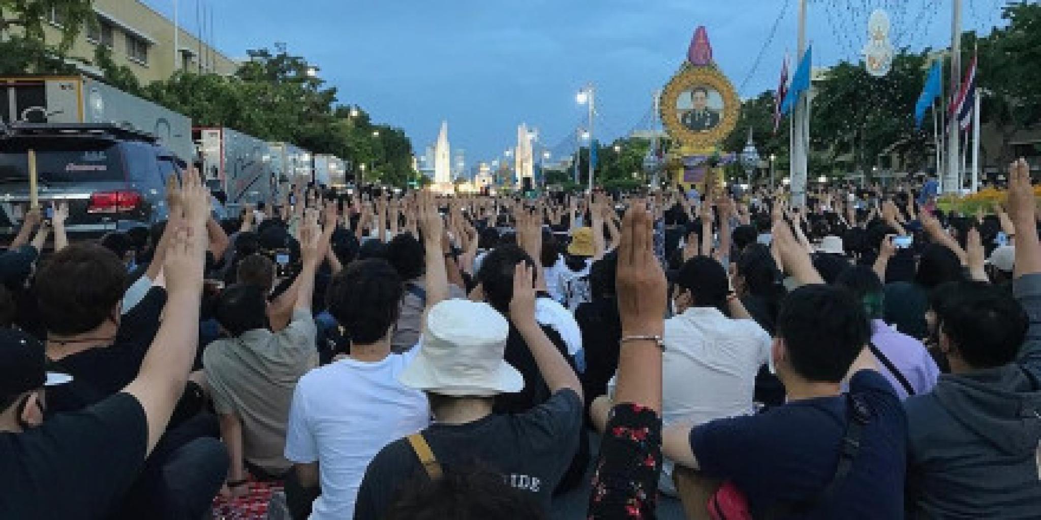 Protesters display three finger salute