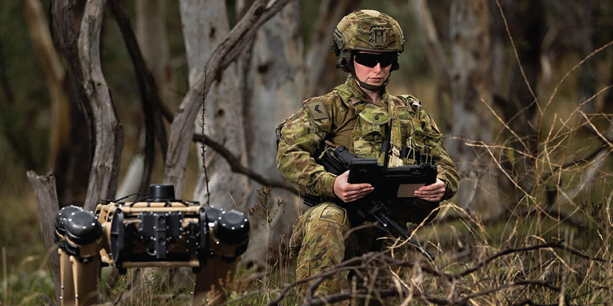 Soldier with robot canine in the bush Soldier with robot canine in the bush